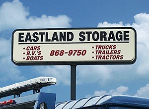 Sign above Eastland Towing's storage lot.